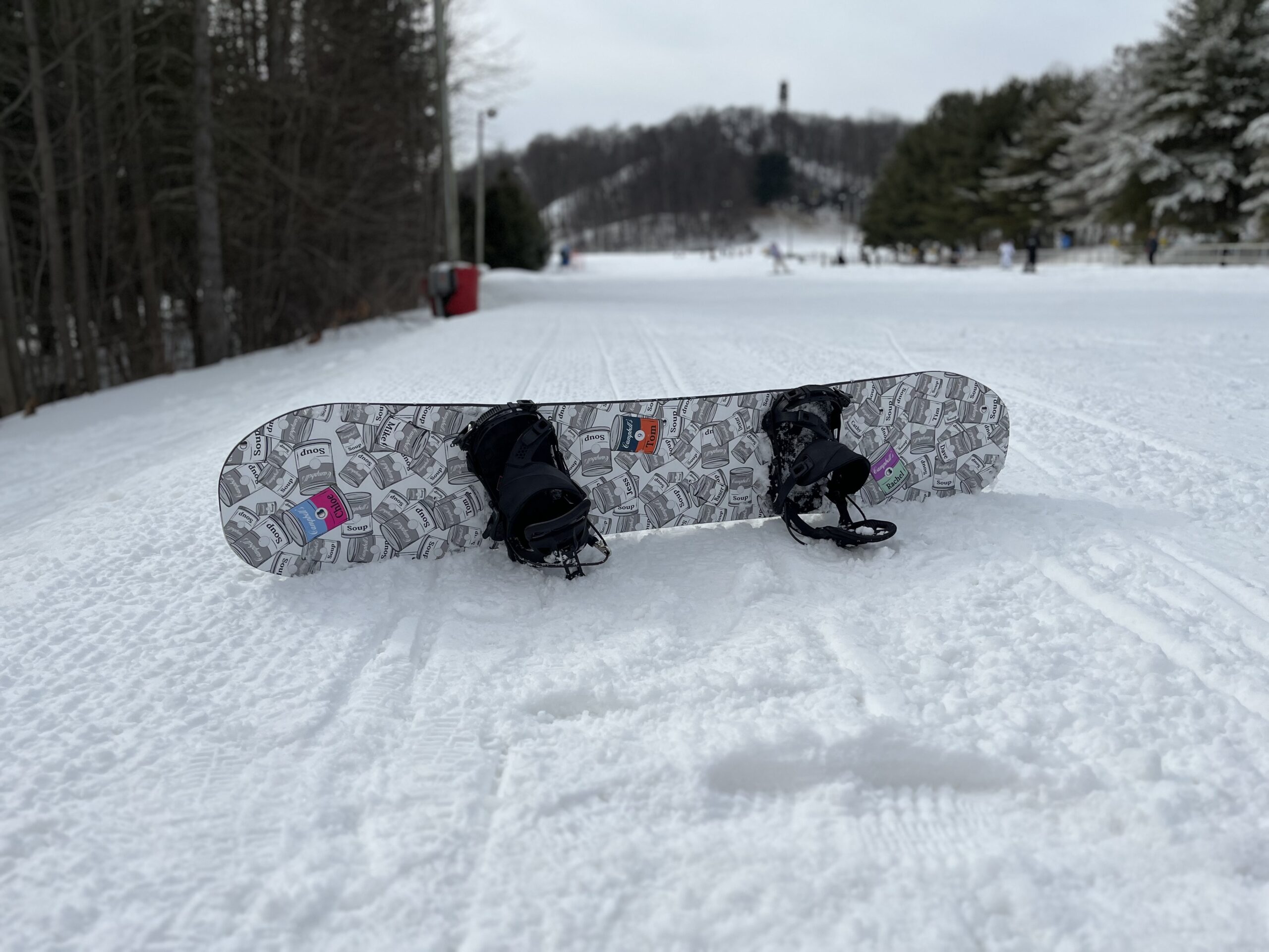 snowboard on mountain propped up in the snow