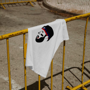 white tee shirt hanging on yellow street barrier