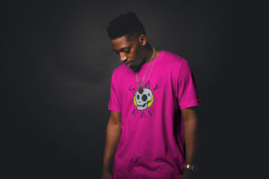 Man in pink shirt with star rad and skull