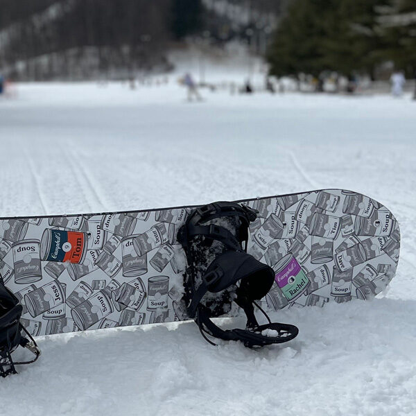 snowboard on mountain propped up in the snow