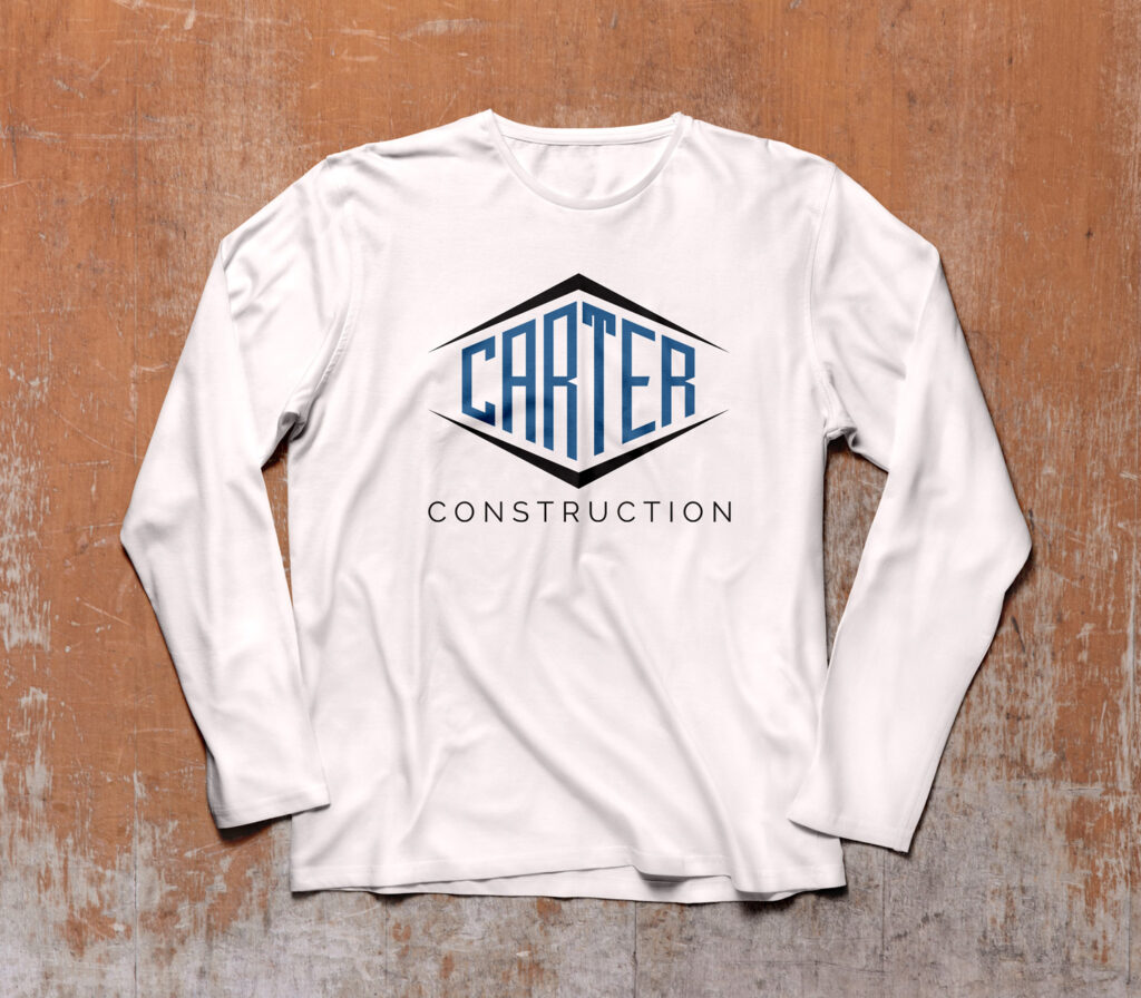 Carter construction logo on white long sleeve shirt on wood background