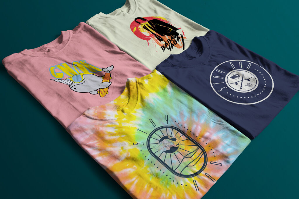 four tee shirts laid out flat showing different designs